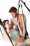 Couple sitting in a wild side blue sex swing
